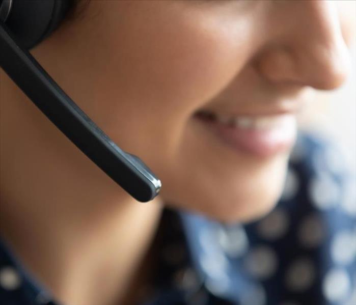 A close up of emergency operator at SERVPRO taking your call. She is smiling as someone who cares as she listens to the needs