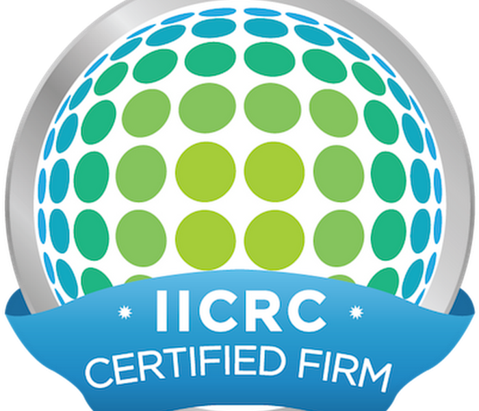 The IICRC certified logo - white background with lime green and teal dots that are shaped into a globe